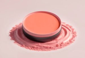 Picture of orange/coral coloured cream blush in a circular pot.
